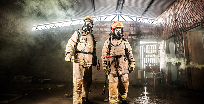 Firefighters in recently extinguished building