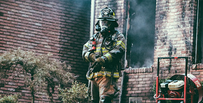 Firefighter outside burning building