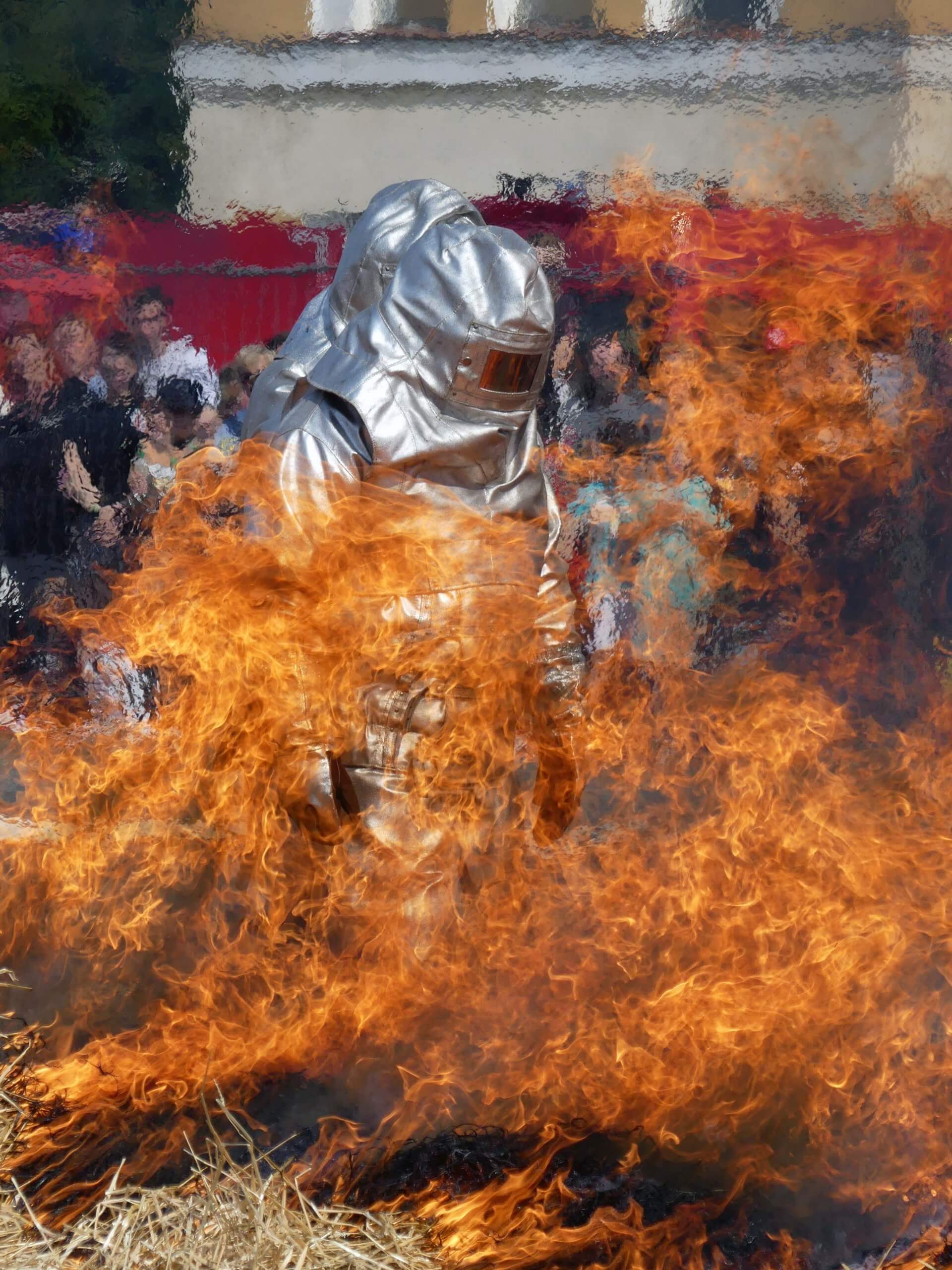 Firefighter wearing a proximity suit entering a fire.