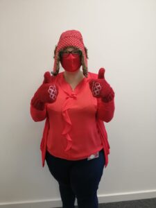 Staff wearing all red including mask, hat and gloves